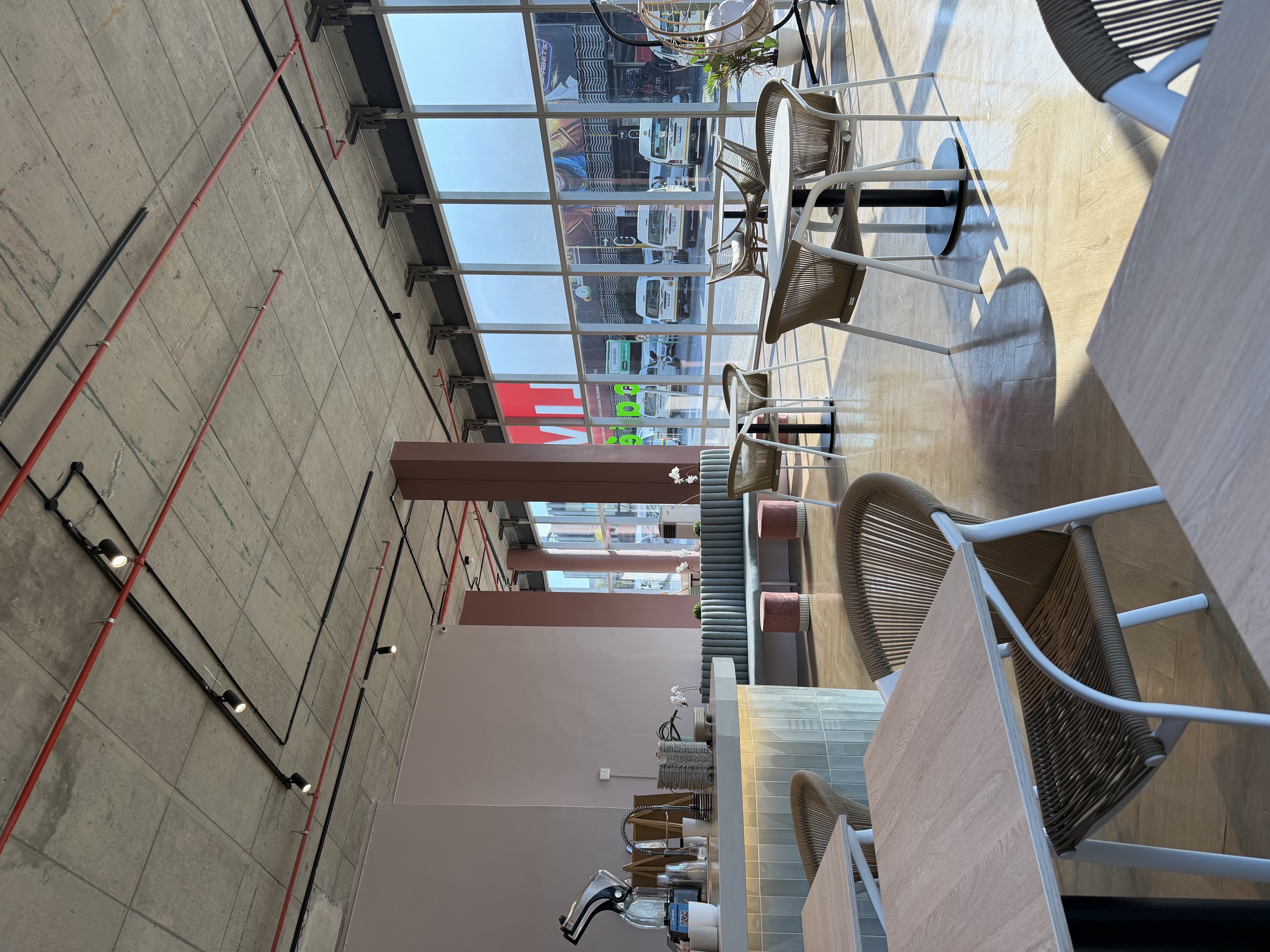 The counter at Live Cafe, with green tiles and wooden shelves